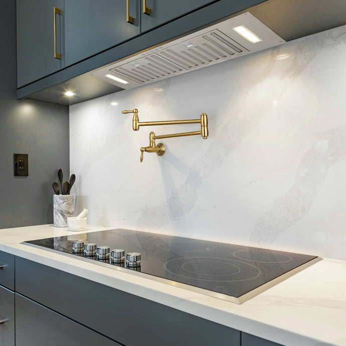Modern kitchen with a gold faucet and gray cabinets