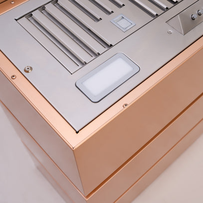 Close-up of a metallic kitchen appliance with a beige base
