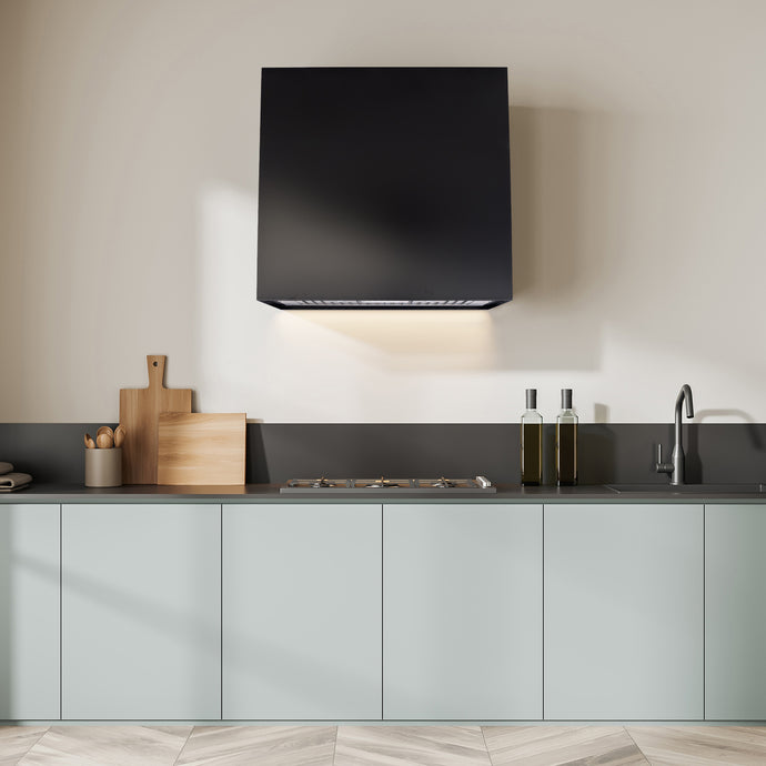 Modern kitchen with black hood, countertop items, and light gray cabinets.