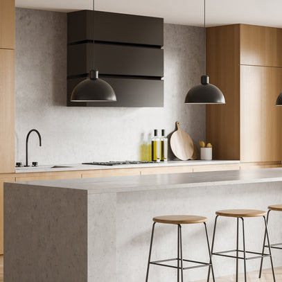 Modern kitchen with wooden cabinets, black range hood, and bar stools.