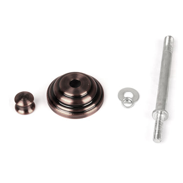 Set of metal components including a large round piece, smaller round piece, washer, and bolt on a white background
