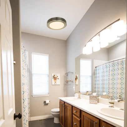 Bathroom with wooden vanity, mirror, and shower curtain