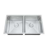 Stainless steel double basin kitchen sink on a white background