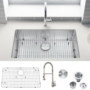 Stainless steel kitchen sink with faucet and accessories on a white background