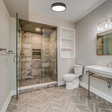 Modern bathroom with shower, toilet, and sink.