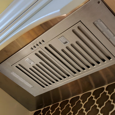 Stainless steel range hood in a kitchen setting
