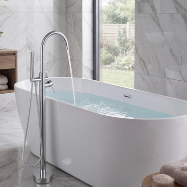 Modern freestanding bathtub with a chrome faucet in a bathroom setting.