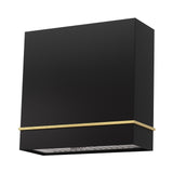 Black range hood with gold trim on a white background