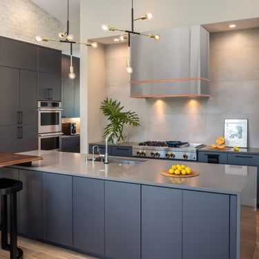 Modern kitchen with gray cabinets, stainless steel appliances, and a island.