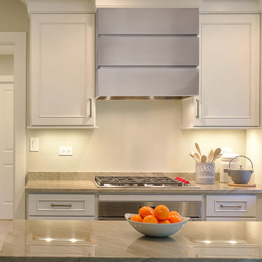 Modern kitchen with stainless steel range hood and countertop