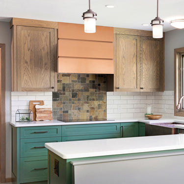 Modern kitchen with wooden cabinets, green lower cabinets, and a white island.