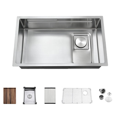 Stainless steel kitchen sink with accessories on a white background