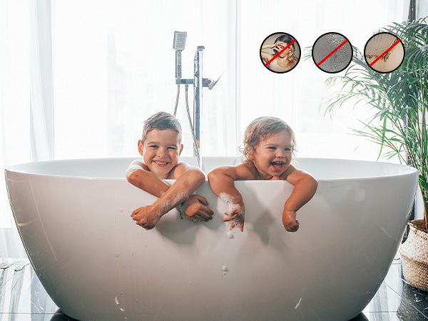 Two children in a bathtub with a plant and shower head in the background