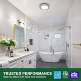 Modern bathroom with white marble walls, a freestanding bathtub, and a shower area. Certifications at the bottom indicate safety for use over tubs and showers.