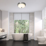 Modern bathroom with a freestanding bathtub, toilet, and large window overlooking trees.