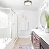 Modern bathroom with shower, sink, and vanity area.