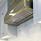 Modern kitchen hood with gold accents in a white kitchen setting