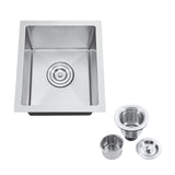 Stainless steel kitchen sink with accessories on a white background