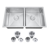 Stainless steel kitchen sink with drainboards and accessories on a white background