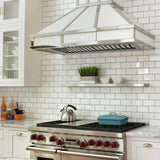 Modern kitchen with stainless steel stove and range hood against a white tiled wall.