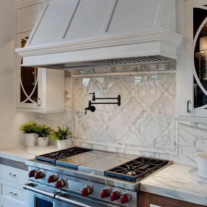 Modern kitchen with stainless steel stove and marble backsplash
