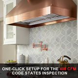 Kitchen with copper range hood and decorative wall tiles, featuring text about one-click setup for 400 CFM code states inspection.