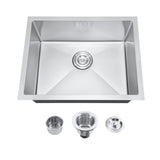 Stainless steel kitchen sink with accessories on a white background
