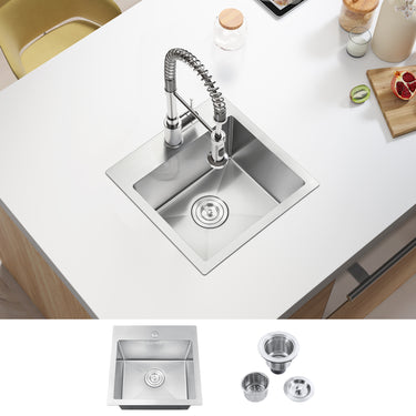 Stainless steel kitchen sink with faucet on a white countertop, accompanied by additional components.