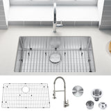 Stainless steel kitchen sink with faucet and accessories on a white countertop.