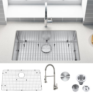 Stainless steel kitchen sink with faucet and accessories on a white countertop.
