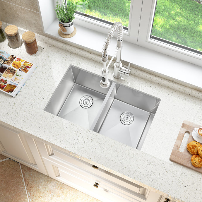 Stainless steel kitchen sink with faucet on a light-colored countertop.